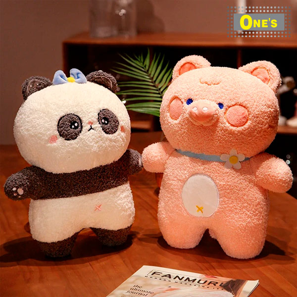 Two stuffed animals sitting next to each other on a table. They are panda and pig.